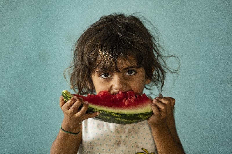 A girl eats a watermelon slice while at a school building where Syrians  displaced from the area of Ras al-Ain by the Turkish offensive on the northeast â€“ are staying in the city of Hasakah. (Photo by Delil Souleiman/AFP Photo)